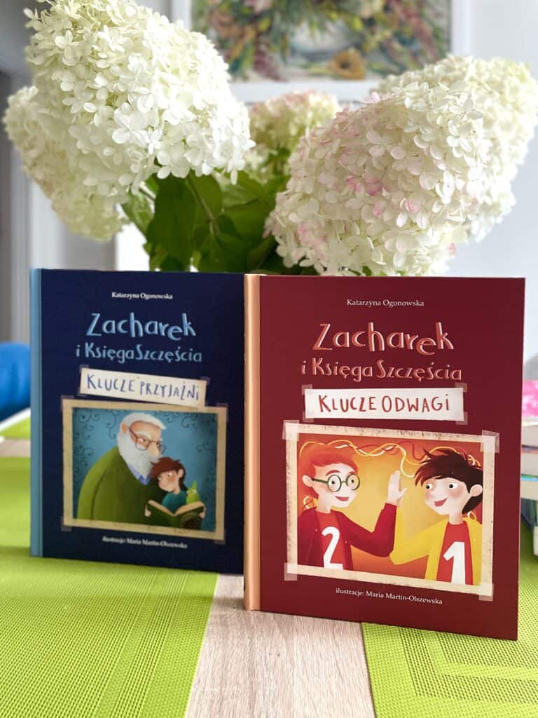 Two children's books on a table with flowers.