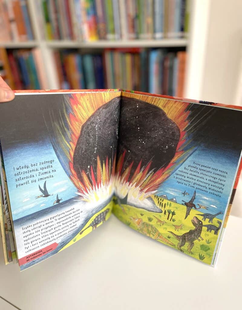 A book with an image of a volcano and dinosaurs.